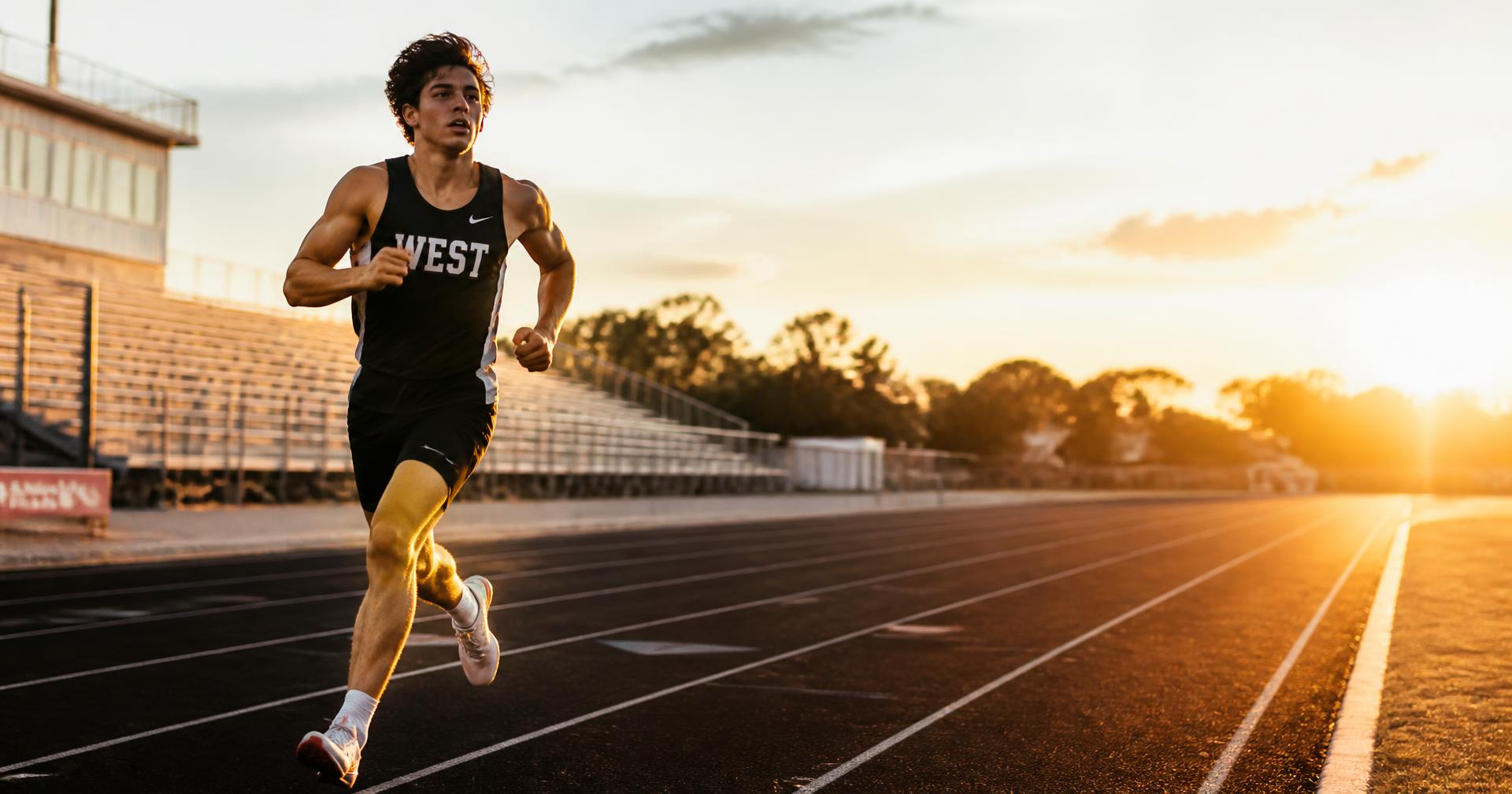 Track athlete running at sunset